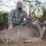 Hunter poses with his big whitetail buck
