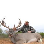 Hunter behind his 176” whitetail buck